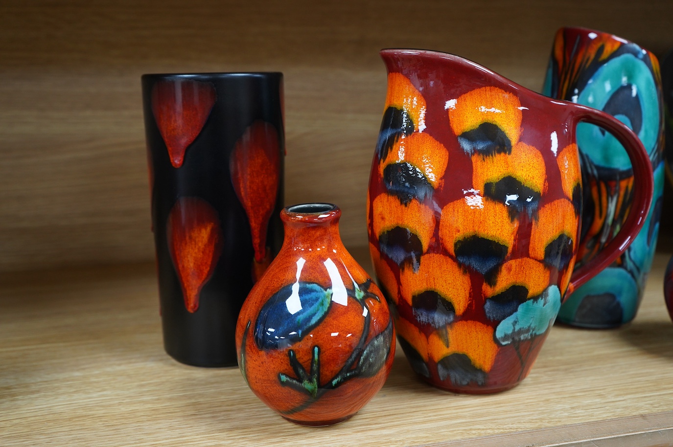 A Poole ‘Galaxy’ Pillar vase, Poole vase by Andrew Tanner, two bud vases and another, tallest 24cm (5). Condition - Andrew Tanner vase crazed, otherwise good